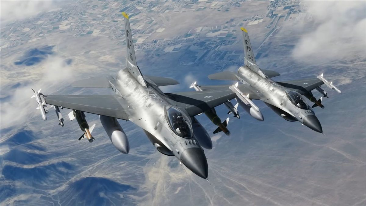 Two F-16 fighter jets flying in formation above the clouds
